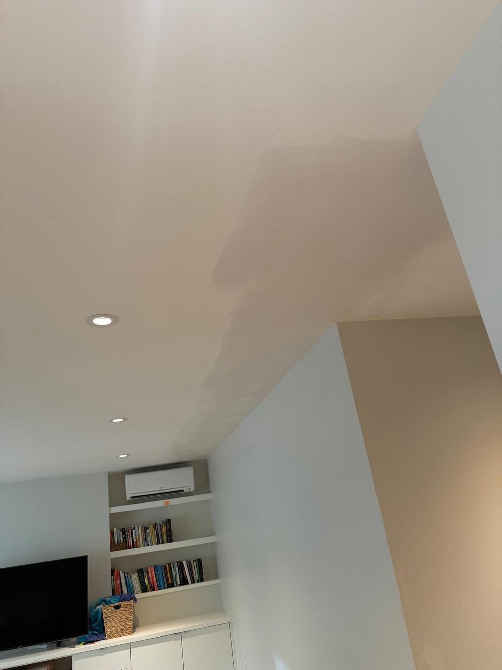Ceiling patch taped and mudded, with the screws and seams covered, before painting